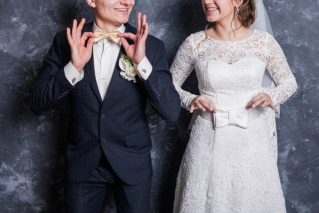 Workers in flat caps and waistcoats assembling a ship's propeller shaft in a 1920s shipyard